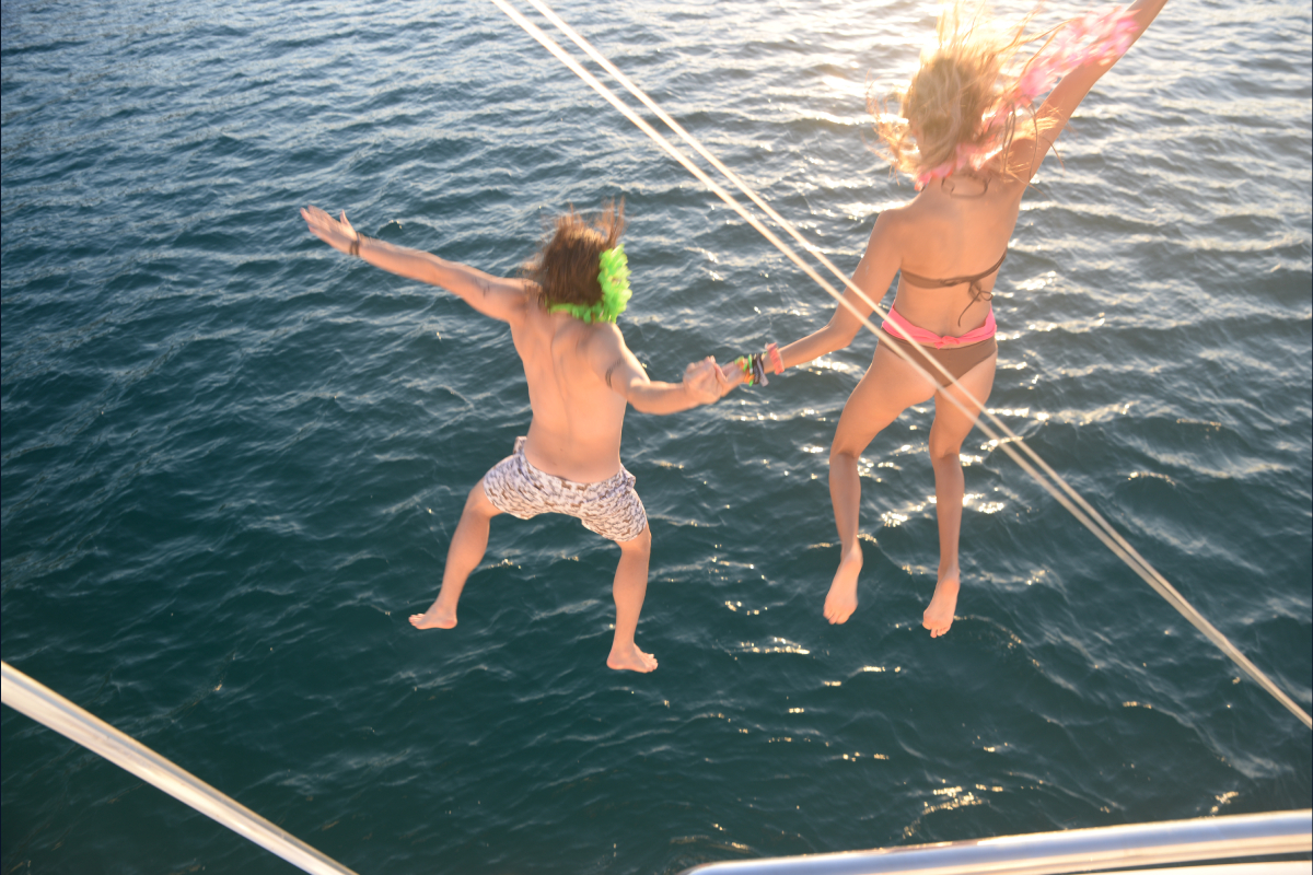Humpback whale breaching next to private charter yacht Sea of Cortez whale watching Cabo