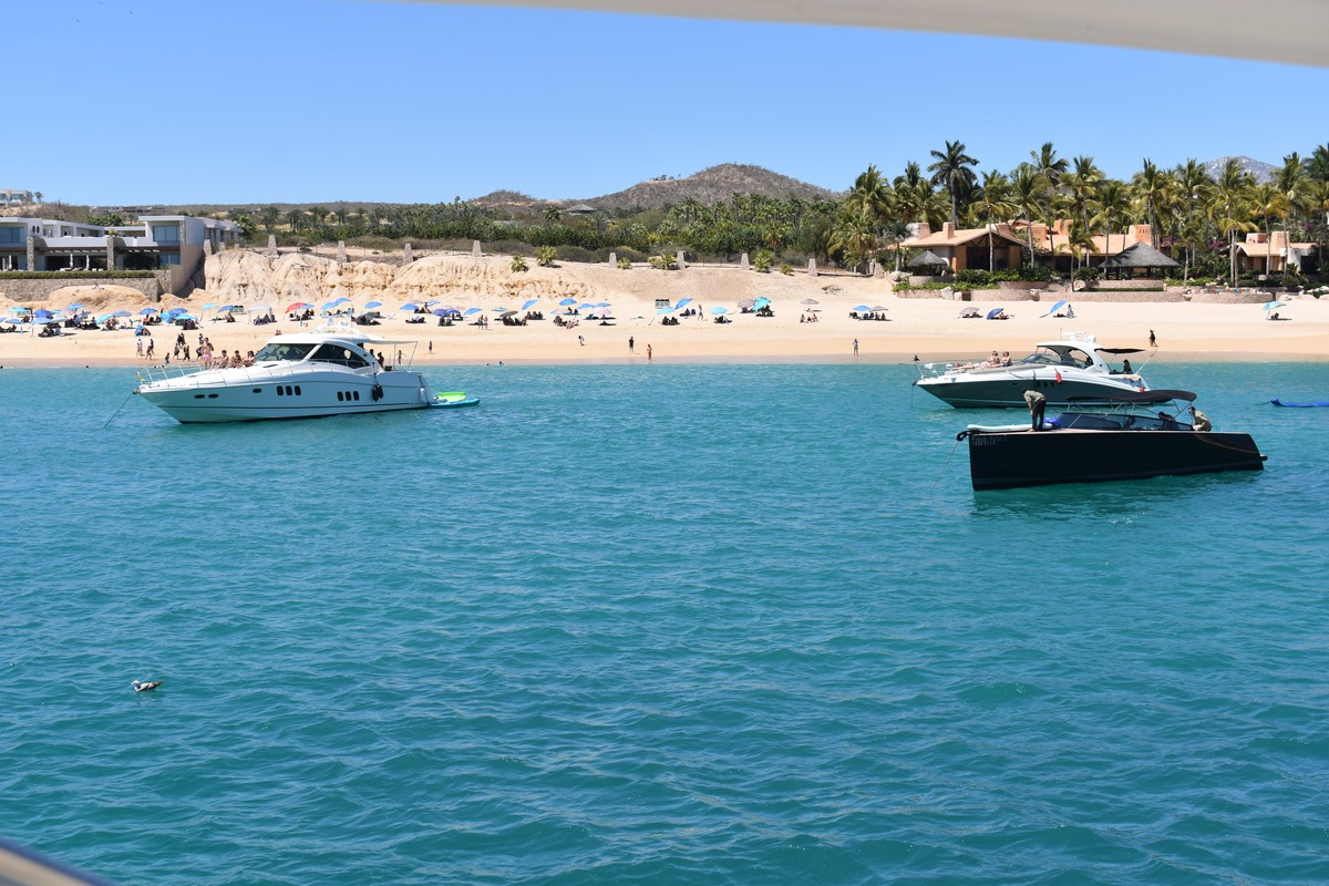 Anniversary dinner setup on yacht deck candles flowers champagne romantic Cabo sunset