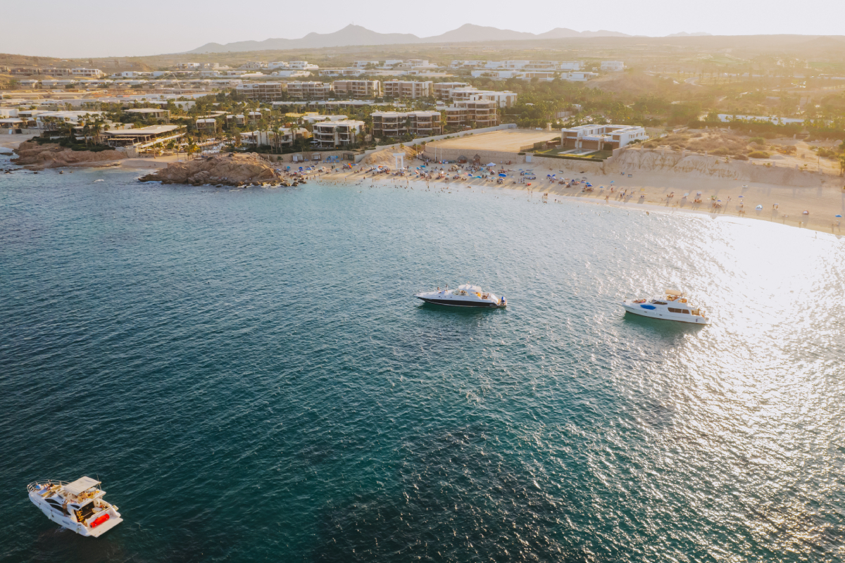 Wedding ceremony on yacht deck with El Arco rock formation in background Cabo San Lucas
